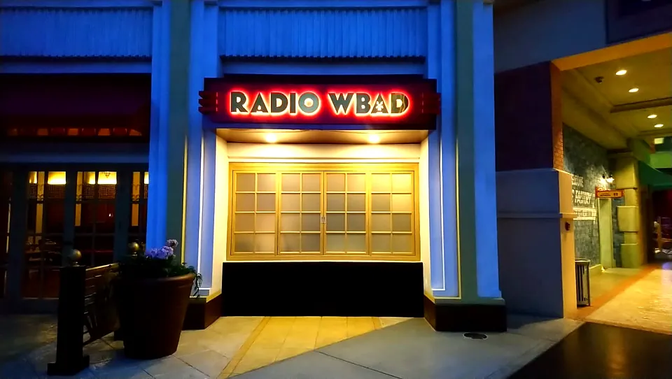 Illuminated Radio WBAD letter sign on a themed facade at Warner Bros. World Abu Dhabi